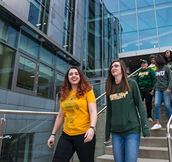 Students walking down stairs. Links to Gifts of Appreciated Securities
